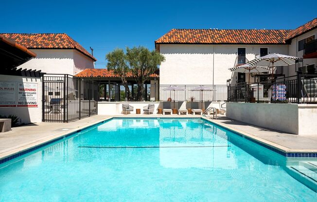 A pool with a warning sign and no diving sign.
