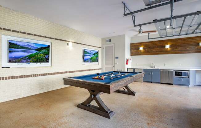 a games room with a pool table and a painting on the wall