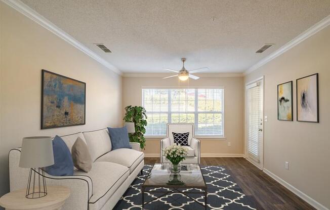 a living room with couches and a large window