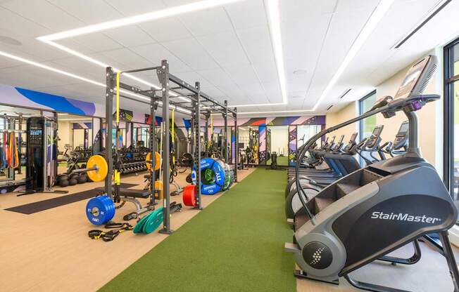 A gym with a StairMaster and other exercise equipment.