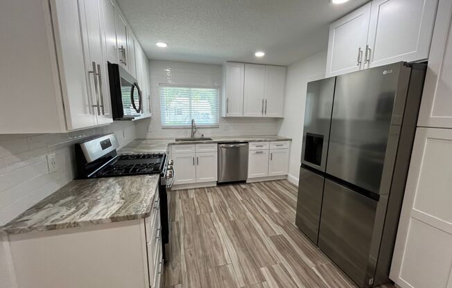 Wow! Fully remodeled four bedroom 3 bath. Amazing location- watch the fireworks over the treetops from your own front porch!