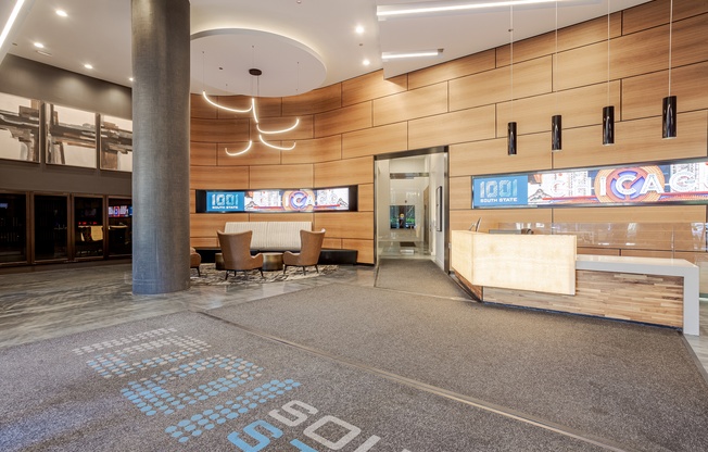 A lobby area with a large carpet that says