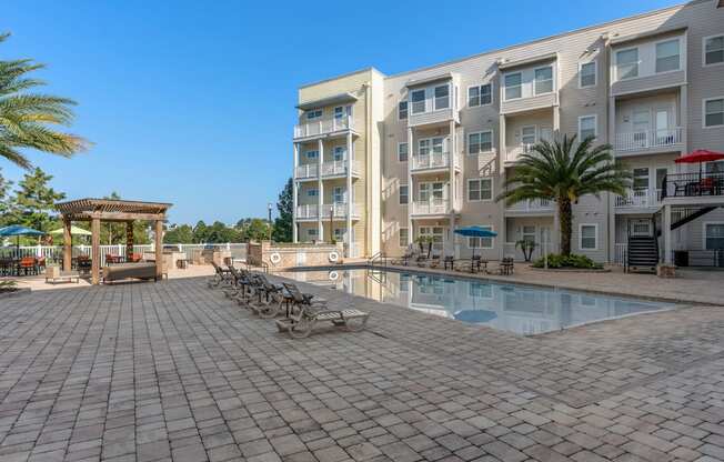 a large swimming pool in front of an apartment building