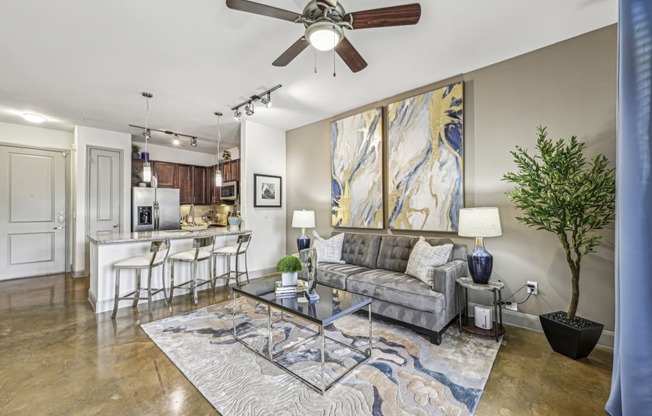 a living room with a couch and a ceiling fan