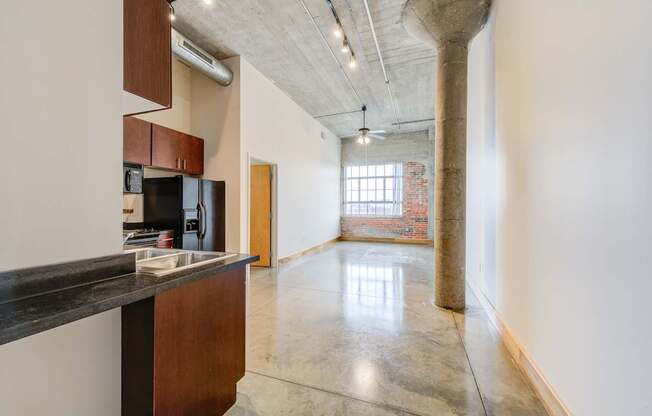 A kitchen with a counter top and a refrigerator.