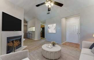 A living room with a fireplace and a television.