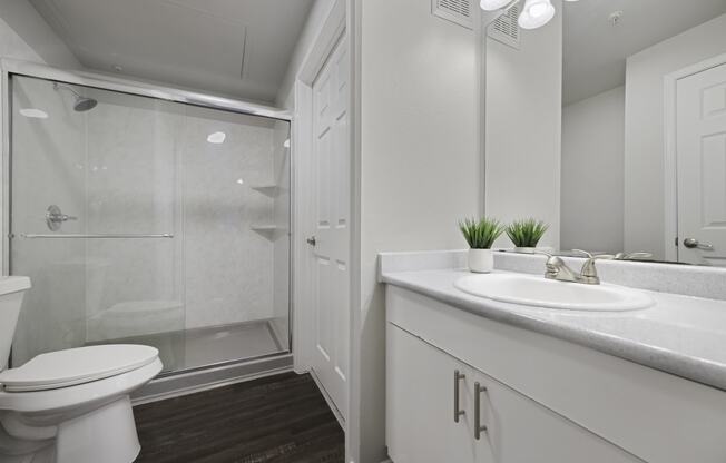 a bathroom with a toilet sink and shower