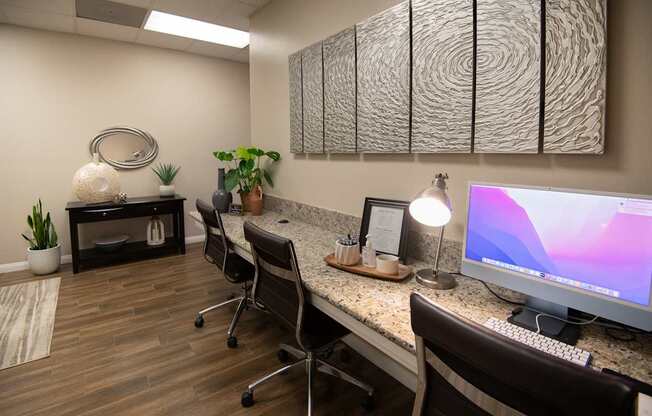 A modern office with a wooden desk and a computer monitor.