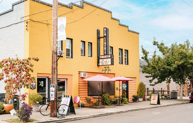 A yellow building with a red umbrella outside.