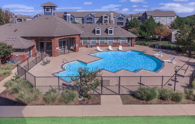 a house with a pool in front of a building