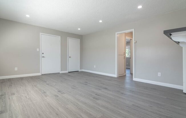 the spacious living room is open to the dining room and kitchen