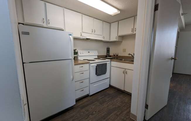 a kitchen with white appliances and white cabinets