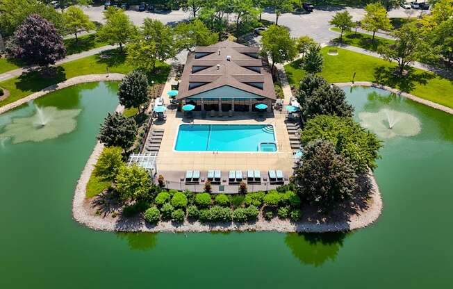A large building with a pool in front of it.