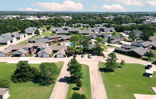 A suburban neighborhood with houses and green lawns.