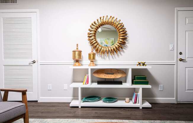 a living room with a mirror and a white shelf  at The Park at Chesterfield Apartment Homes, Tampa, FL, 33617