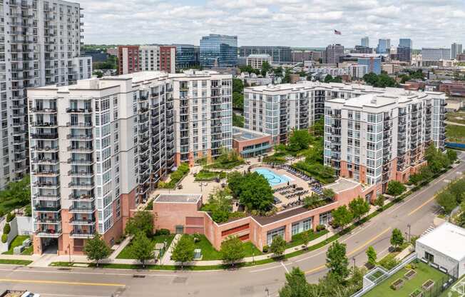 an aerial view of a city with tall buildings and a swimming pool