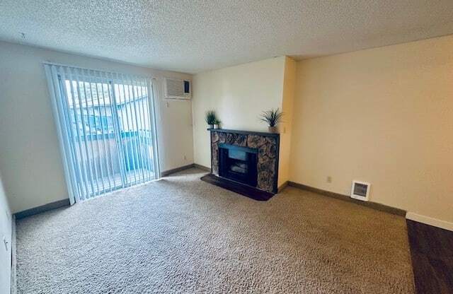 an empty living room with a fireplace and a window