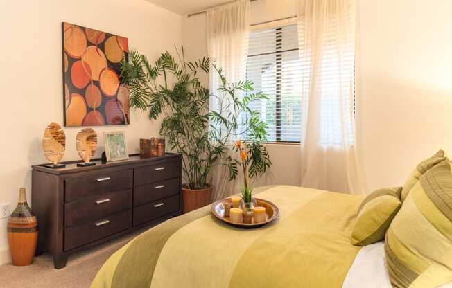 a bedroom with a large bed and a dresser