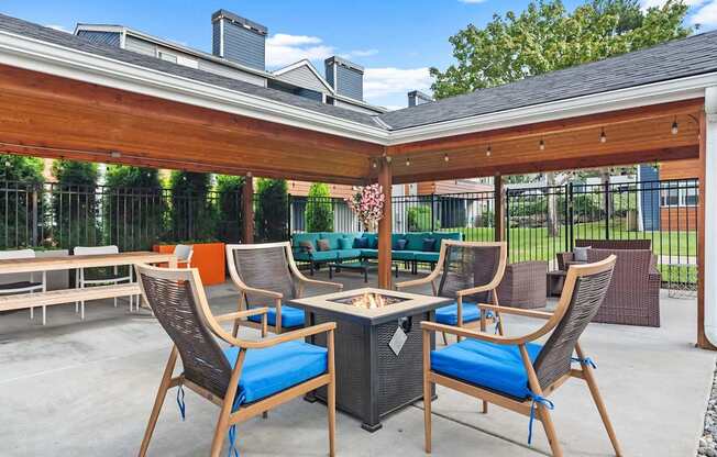 A patio with a table and chairs under a roof. at Northpoint Apartments, Washington, 98407