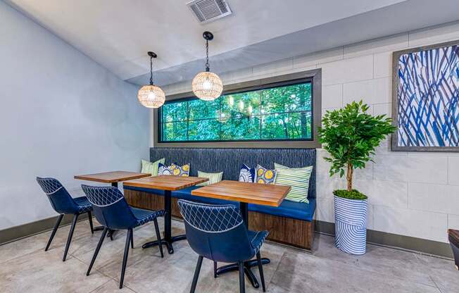 A dining room with a table and chairs.