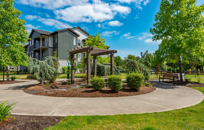 a park with a pavilion and benches in front of a building