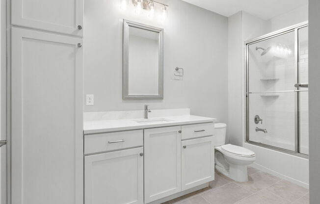 A white bathroom with a toilet, sink, and mirror at Madison Prickett Preserve, Pennsylvania, 19067