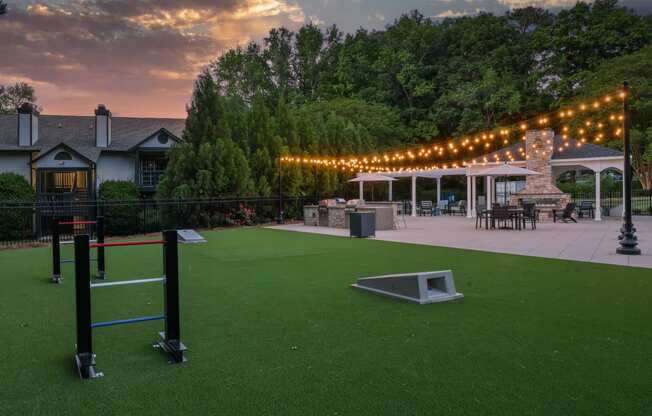 a backyard with a baseball field and a patio with lights