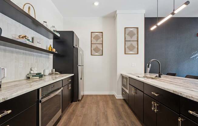 A kitchen with black cabinets and a white counter top.