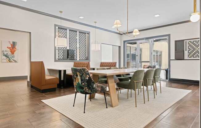 A dining room with a table surrounded by chairs.