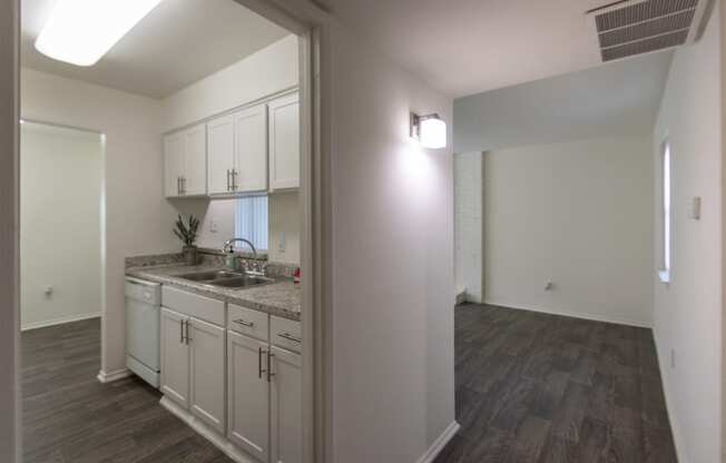 This is a photo of the kitchen from the entryway of the 970 square foot 2 bedroom, 2 bath apartment at Preston Park Apartments in Dallas, TX