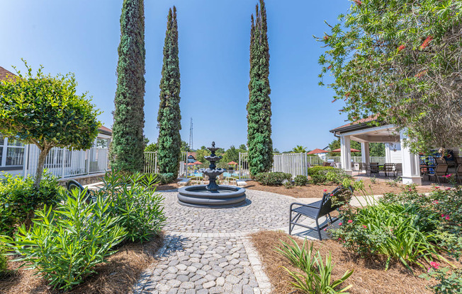 community courtyard with a fountain and a gazebo with chairs in the background