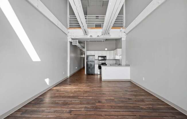 A long hallway with a kitchen at the end.