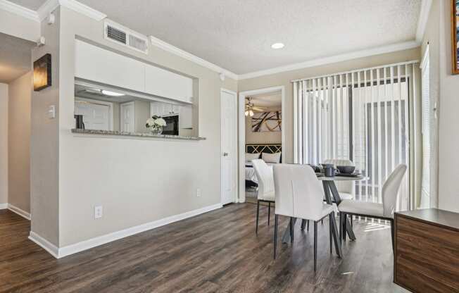 a living room and dining room with a table and chairs