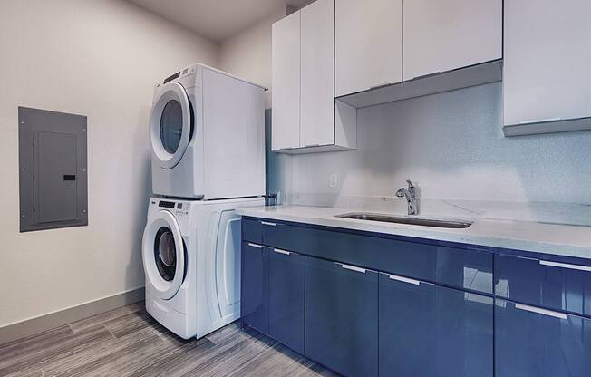 A washing machine is placed in a laundry room.