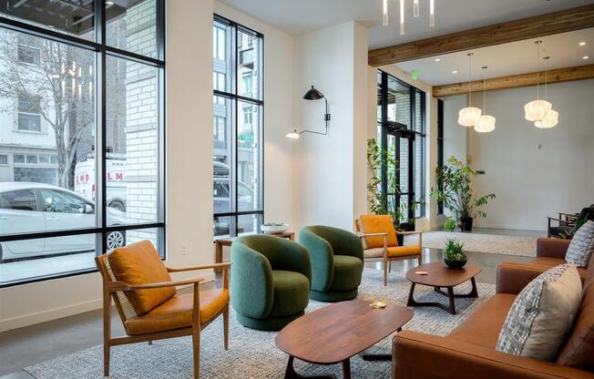 a living room with couches and chairs and a large window