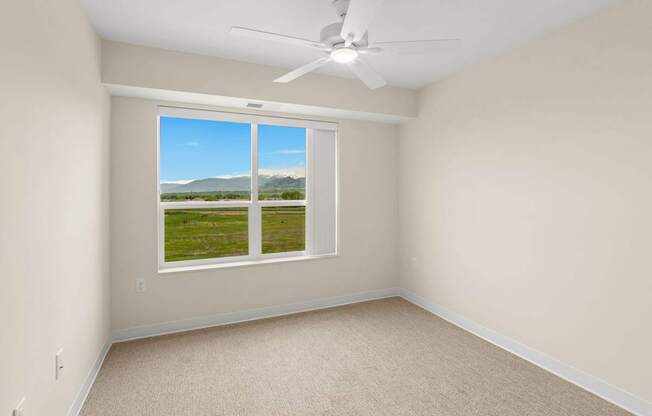A room with a window showing a view of the outdoors.