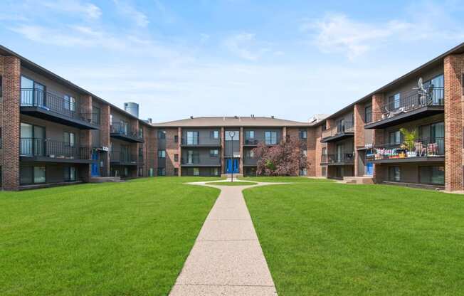 a grassy area with a walkway in at Lafayette Park Place, Detroit, MI, Detroit, MI, 48207