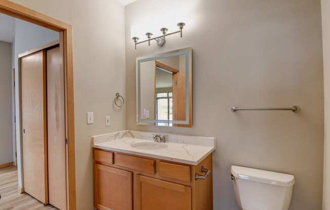 the master ensuite bathroom has a large mirror and a toilet