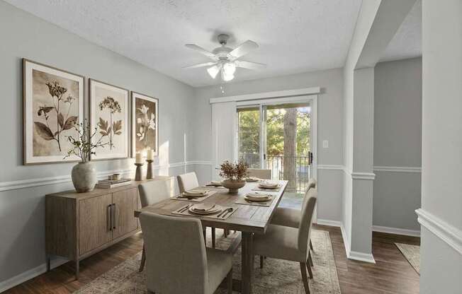 A dining room with a table set for four.