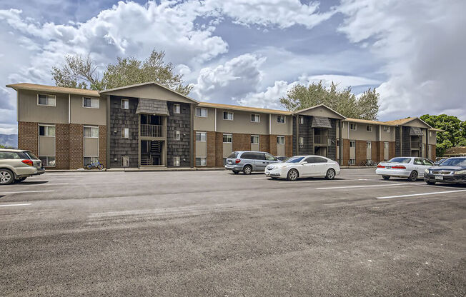 an empty parking lot in front of an apartment building