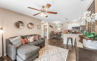 a living room with a couch and a ceiling fan