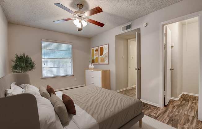 a bedroom with a large bed and a ceiling fan