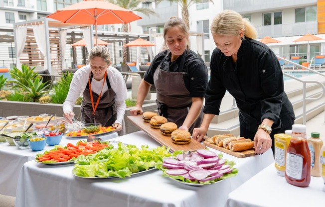 a group of women preparing food on a table