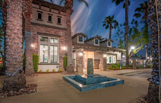 A house with a fountain in front of it.