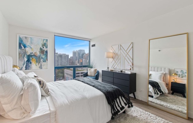 a bedroom with a bed and a large window