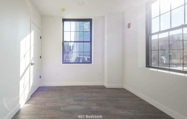 an empty room with white walls and a window