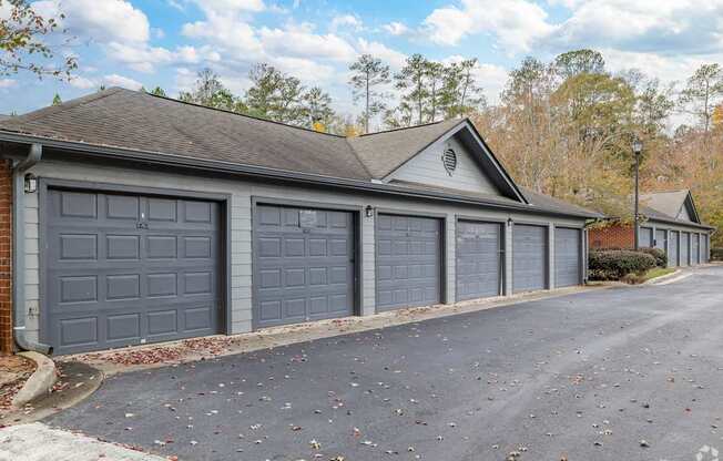 A two-car garage with a brick wall and a gabled roof.