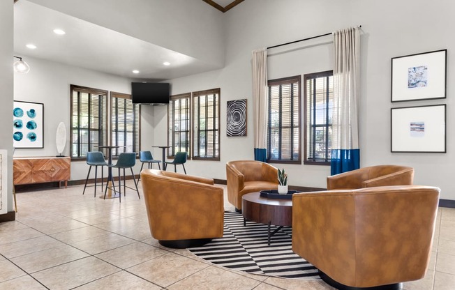 a resident clubhouse with couches chairs and a coffee table