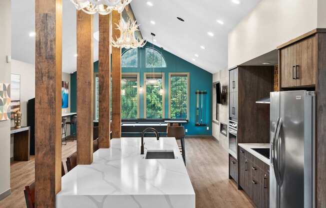 A modern kitchen with a large island and stainless steel appliances.