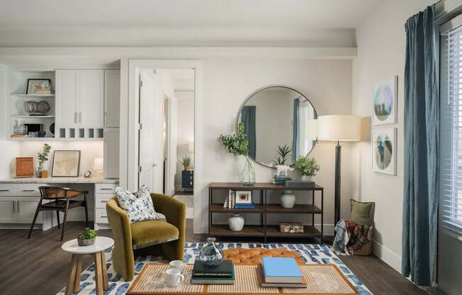 A living room with a yellow chair and a coffee table.